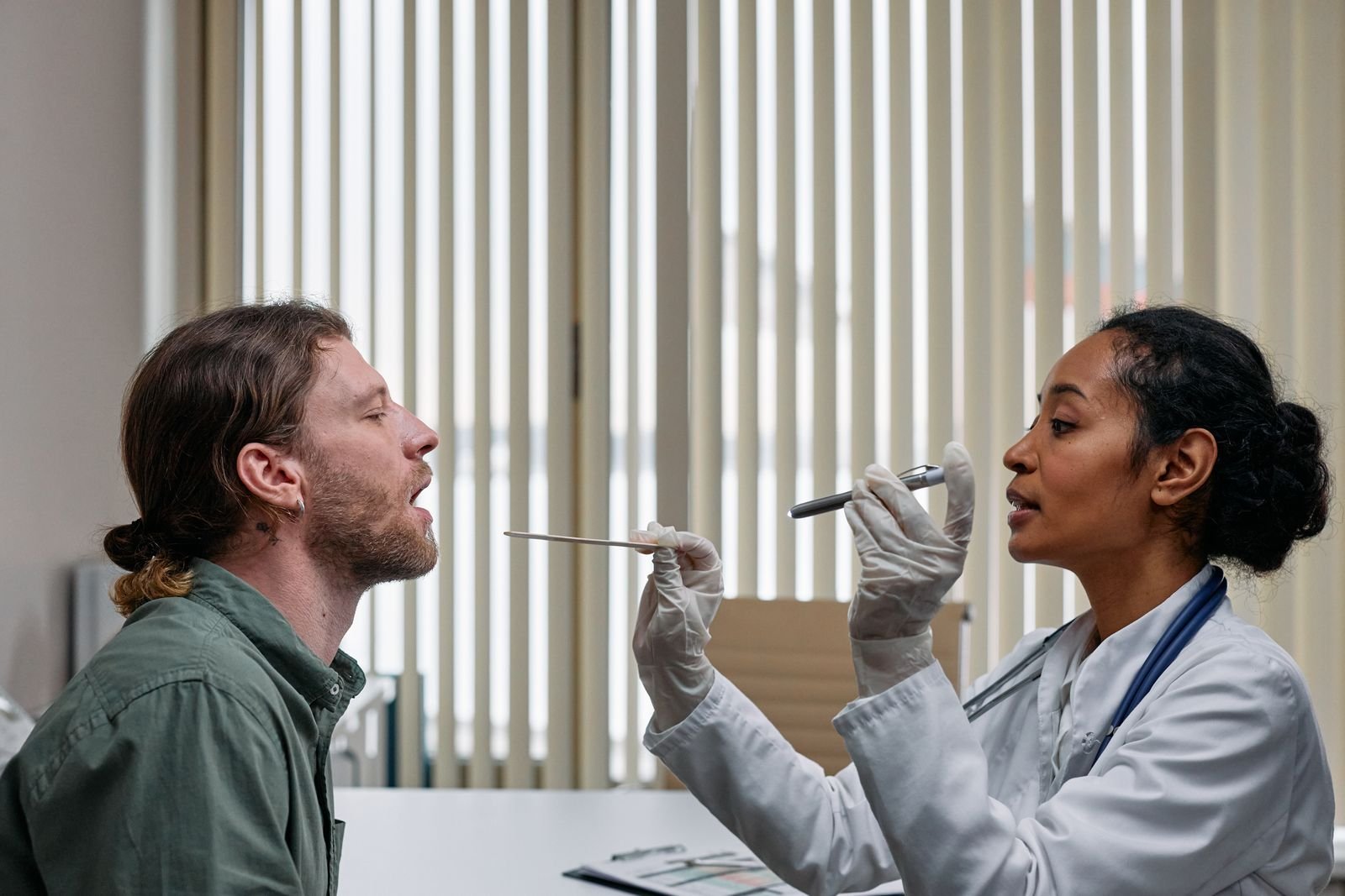 Doctor examining a patient during an ENT consultation