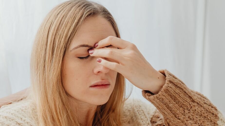 Woman feeling dizzy and holding her head