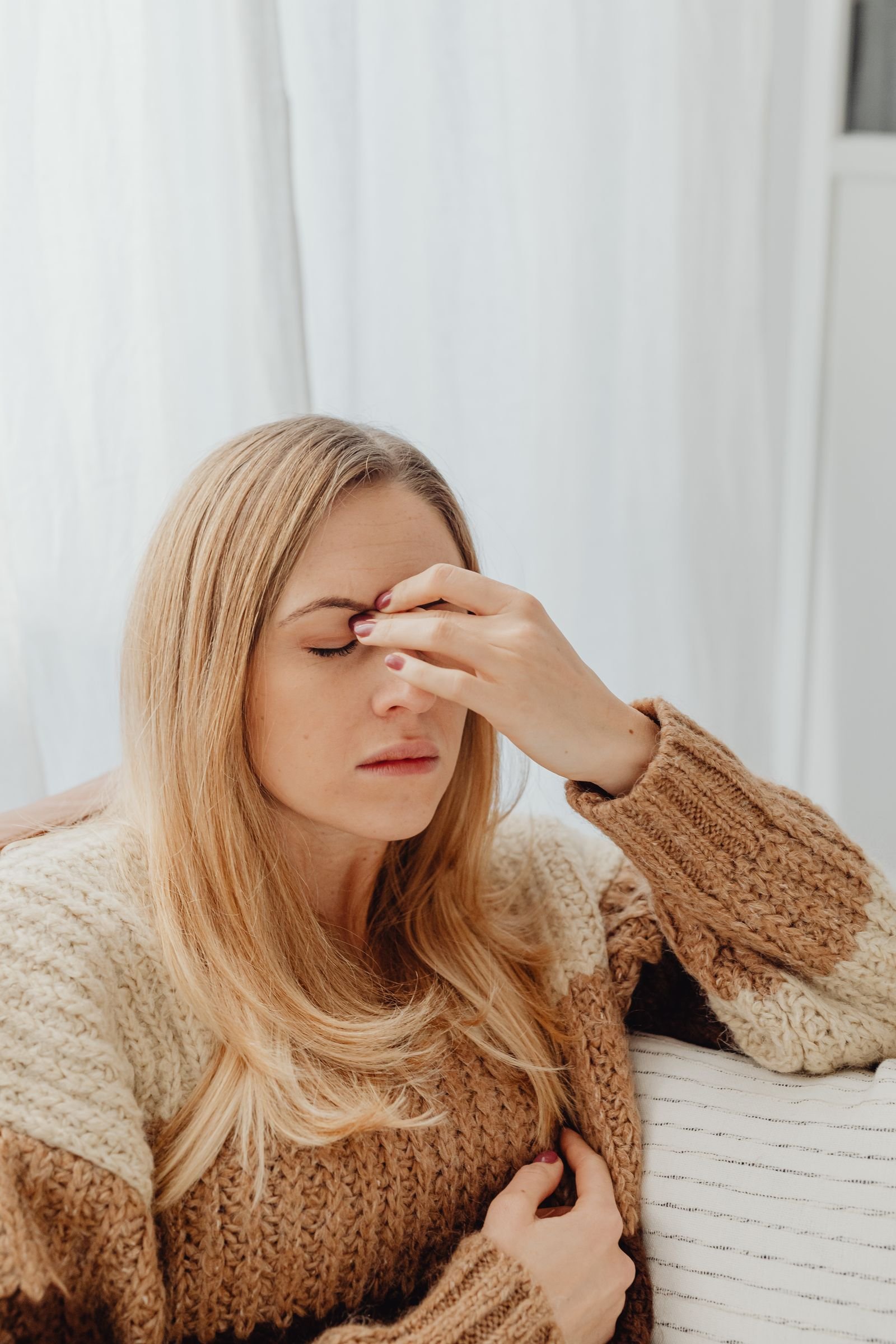 Woman feeling dizzy and holding her head