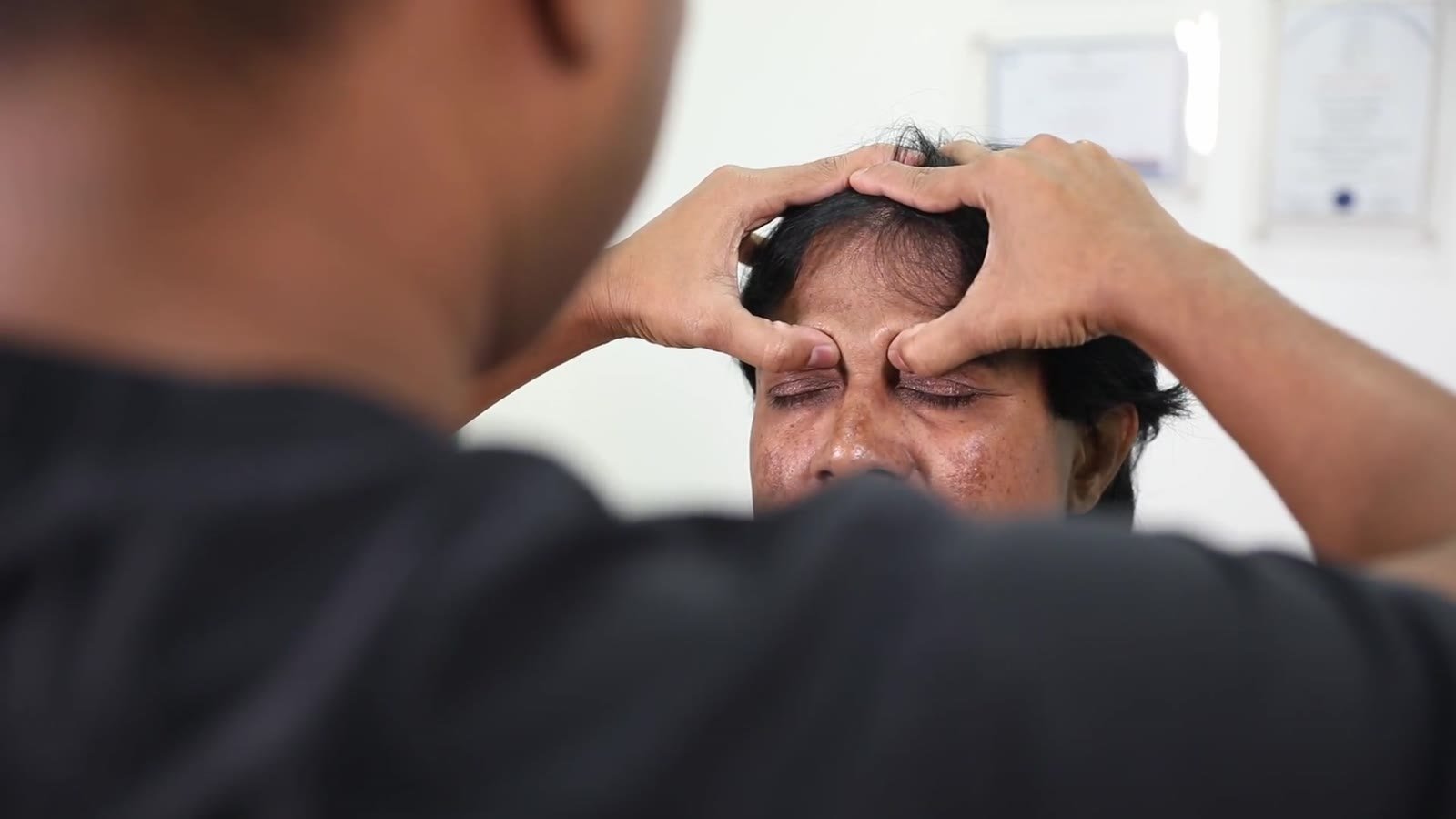 Doctor checking a patient's sinuses